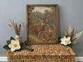 Buck and doe in a muted vintage woodland painting, framed and styled with magnolias.